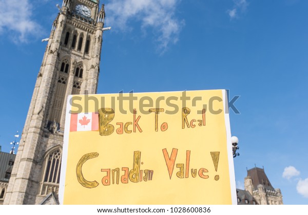 OTTAWA - FEB 18,2018: Canadians demonstrate on\
Parliament Hill to ask  Prime Minister to stop dividing people and\
to apologize for taking side with hijab hoaxers. Chinese signs:\
Asians silent no more!