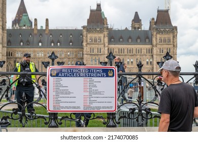 OTTAWA - JULY 1, 2022: A Pedestrian Looking At The Poster By The Police Check Point About Restricted Items That Cannot Be Brought To Parliament Hill.