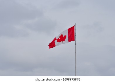 Ottawa, Ontario, Canada, 2020. Canadian National Flag Flying High Against The Blue Sky. Called L'Unifolié In French Consists Of A Red Field With White Square At Its Centre & 11-pointed Red Maple Leaf