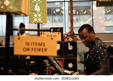 Ottawa, Ontario, Canada - December 31, 2019: Cashier On Checkout #4 (10 Items Or Fewer) At The Whole Foods Market At Lansdowne.