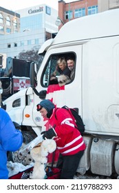 Ottawa, Ontario, Canada - February 5, 2022: Person Giving Trucker Pack Of Dog Food To Support