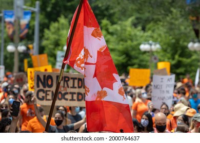 OTTAWA, ONTARIO, CANADA - JULY 1, 2021: A Canadian Flag Raised At A Protest In Downtown Ottawa With Orange Hand Prints Representing Indigenous Children Of Canada's Residential School System.