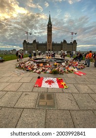 Ottawa Ontario Canada July 1 2021. Canada Day Canadian Parliament Hill Centennial flame. Crowd and remembrance protest display for indigenous peoples residential school victims.