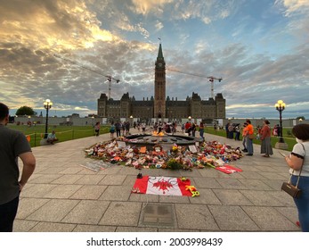 Ottawa Ontario Canada July 1 2021. Canada Day Canadian Parliament Hill Centennial flame. Crowd and remembrance display honoring indigenous peoples residential school victims.
