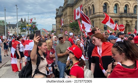 Ottawa Ontario Canada July 1 2022. Canada Day 2022 Crowds Of People Waving And Wearing Canadian Flags And Clothing Celebrating On Wellington Street.