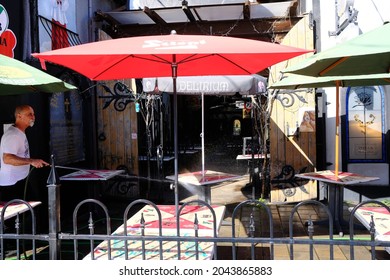 Ottawa, Ontario, Canada - July 14, 2020: Restaurateur Hosing Down Outdoor Restaurant Patio Distanced Tables As Ontario Enters COVID Stage 3 Reopening.