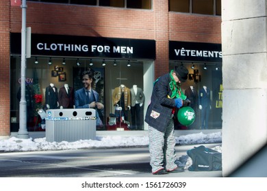 Ottawa Ontario Canada November 16/2019 Man With Black Hat, Green Scarf, Colourful Clothes Making Balloons, Busker, Elf Costume, Christmas Holiday, Street Entertainer