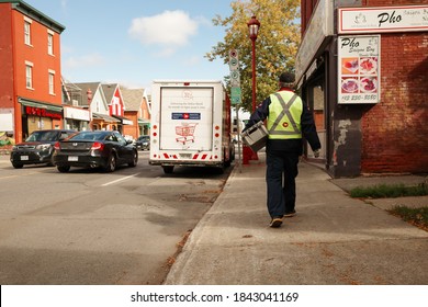 OTTAWA, ONTARIO, CANADA - OCTOBER 8, 2020: A Canada Post Worker Returns To A Delivery Van In Ottawa.