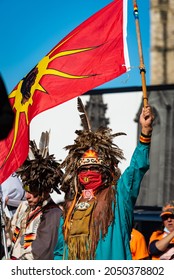 OTTAWA, ONTARIO, CANADA - SEP.T. 30, 2021: A First Nations Man Waves A Red And Yellow Warrior Unity Flag During The First Truth And Reconciliation Day Event, Held At Parliament Hill.