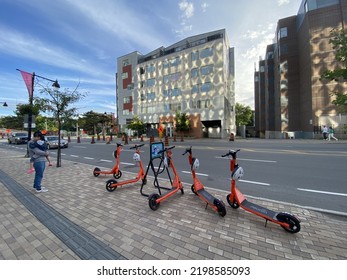 Ottawa Ontario Canada September 4 2022. Neuron Street Scooters Parked In Front Of A Condo Building In Front Of Lansdowne Park Stadium Entrance Way On Bank Street.