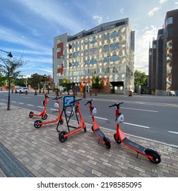 Ottawa Ontario Canada September 4 2022. Neuron Street Scooters Parked In Front Of A Condo Building In Front Of Lansdowne Park Stadium Entrance Way On Bank Street.