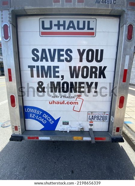 Ottawa Ontario Canada\
September 4 2022. U Haul trailer door sign reading saves you time,\
work and money.
