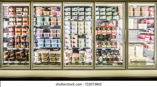 Ottawa, Ontario - September 25, 2017: Different Brands And Flavors Of Ice Cream Stacked On Fridge Shelves In A Supermarket. Huge Glass Door Freezer Aisle With Variety Pack Of Ice Cream. 