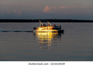 Otter Tail Lake, Minnesota USA July 10, 2022 People On A Pontoon Boat On Otter Tail Lake At Sunset In Rural Minnesota.
