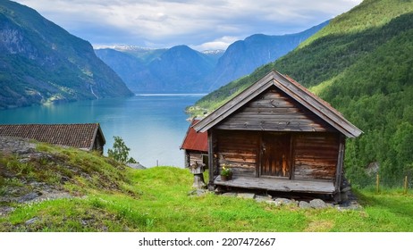 Otternes, Norway - 07012022: Picturesque Wooden Mountain Cabin In Fjord Lake Landscape