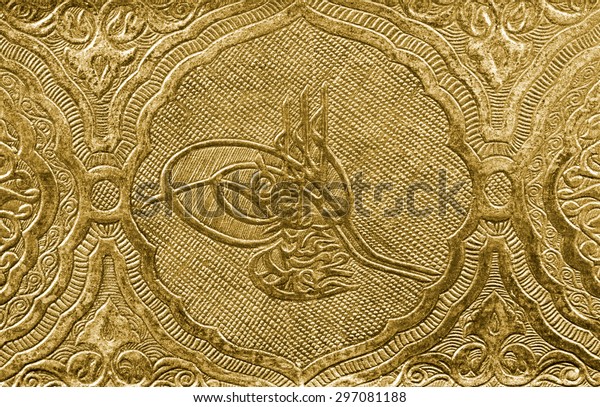 Ottoman tugra sign carved and patterned on gold surface 