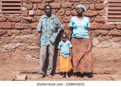 Ouagadougou, Burkina Faso. December 15, 2017. A Family Rests In Front Of A Structure In A Village Near The Capital