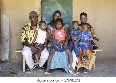 OUAGADOUGOU, BURKINA FASO - NOVEMBER 16: Portrait Of An African Family Outside His Home In Ouagadougou, November 16, 2010