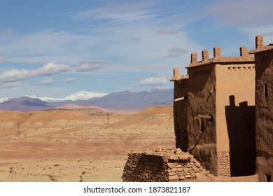 OUARZAZATE, MOROCCO - NOVEMBER 22; 2018  Ksar Of Ait-Ben-Haddou In The High Atlas Mountains Of The Sahara Desert With Snow Capped Mountains In The Background