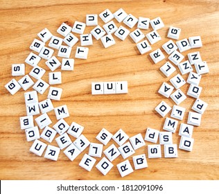 Oui word concept written on a wooden background - Powered by Shutterstock