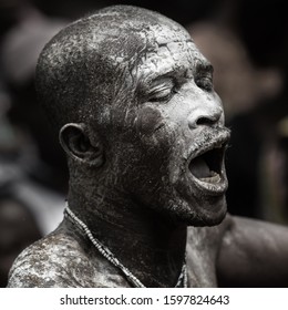 Ouidah, Benin – January 10, 2012: Voodoo Festival - Man Is In A Trance Of The Rhythm Of The Drums And Has Oil And White Powder On His Face.