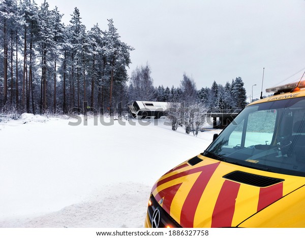 Oulu, Finland - January 3\
2021: Emergency service car on the place of road accident where bus\
almost fallen from the bridge on slippery road at winter time in\
Finland