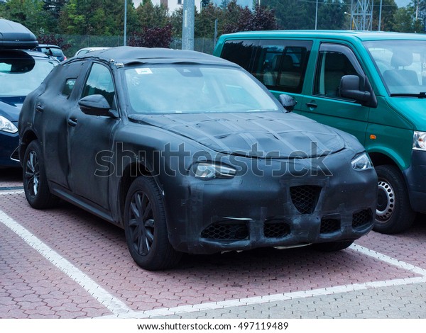 Oulx, Italy _ October  01, 2016  Prototype of a
SUV car camouflaged parked in a public space while is testing on
the road
