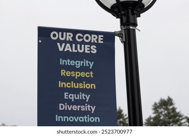 Our Core Values (integrity, respect, inclusion, equity, diversity, innovation) sign hanging off lamp post