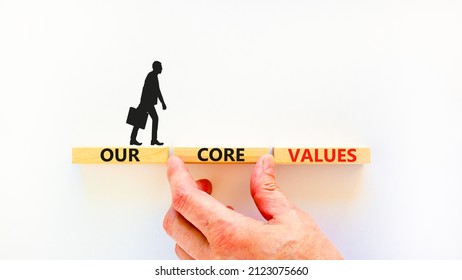Our core values symbol. Concept words Our core values on wooden blocks on a beautiful white table white background. Businessman hand. Business value and our core values concept. Copy space.