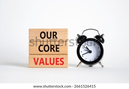 Our core values symbol. Concept words Our core values on wooden blocks. Beautiful white background with alarm clock. Business and Our core values concept. Copy space.