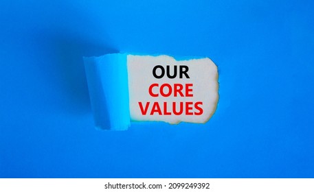 Our core values symbol. Words 'Our core values' appearing behind torn blue paper. Beautiful blue background. Business, our core values concept, copy space.
