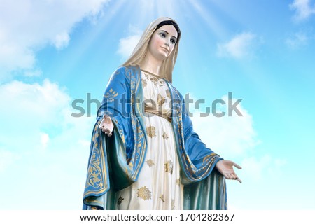 Our lady of grace virgin Mary with Bright Blue Sky and beautiful clouds with abstract colored background and wallpaper.