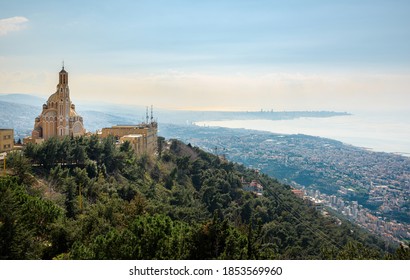 Our Lady Of Lebanon Maronite Church Sits On A Hill Over The Jounieh Bay, With Beirut Capital City In The Background, In Lebanon, Middle East