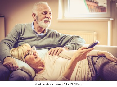 Our Moments Are Always Fulfilled. Mature Couple Watching Television.