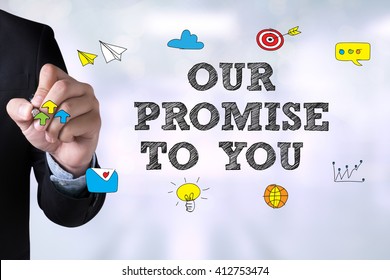 OUR PROMISE TO YOU  And Businessman Drawing Landing Page On Blackboard