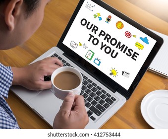 OUR PROMISE TO YOU  Businessman At Work. Close-up Top View Of Man Working On Laptop While Sitting At The Wooden Desk , Coffee