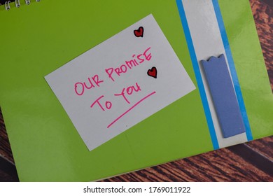 Our Promise To You Text On Sticky Notes Isolated On Office Desk.