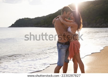 Our tans will fade, but the memories will last forever. A young couple on a calm and tranquil beach.