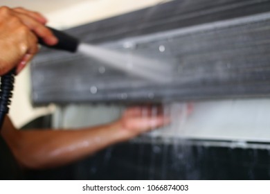 Out Of Focus Air Conditioning Cleaning By Hand Technician Man At Home