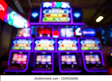 Out of focus blurry image of casino equipment. Blurred slot machines in a casino. - Shutterstock ID 1104326606