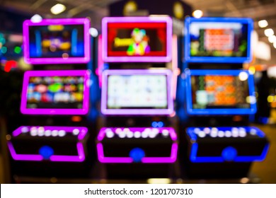 Out Of Focus Blurry Image Of Casino Equipment. Blurred Slot Machines In A Casino.