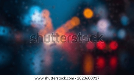 Out of focus city lights create a beautiful bokeh effect with vibrant blue, orange, and red colors, suggesting a lively urban atmosphere.