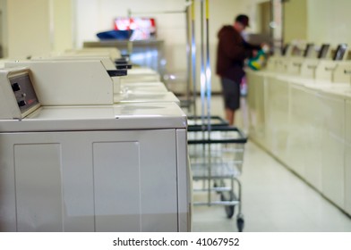 Out Of Focus Man Doing His Wash At A Laundromat