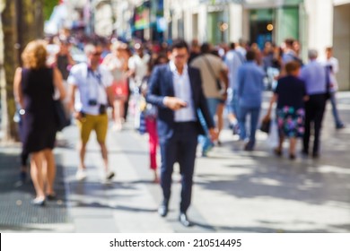 Out Of Focus Picture Of A Crowd Of People Walking In The City 