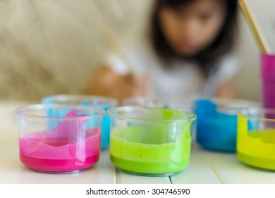 Out Of Focus Shadow Of Little Girl Painting On The Table In Art Subject  Classroom At School