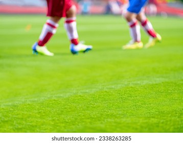 Out of focus shot of soccer balls and legs of soccer players during a soccer training session on green natural soccer pitch. - Powered by Shutterstock