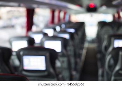 Out Of Focus View Of A Luxury Bus Interior. Empty Business Coach With On Board Head Rest Entertainment System