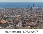 Out of focus view over the rooftops of Barcelona city with the sea on the horizon.