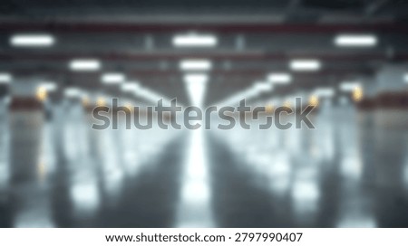 Out of focus view of a symmetrical empty hallway with overhead lights reflecting on the floor