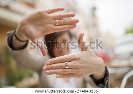 Out of focus woman and framing symbol in natural light outdoors image